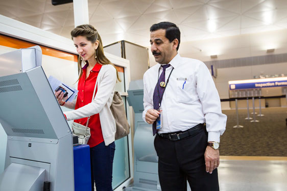 Customs APS Kiosk in Use Olea APS Touch Screen Kiosk