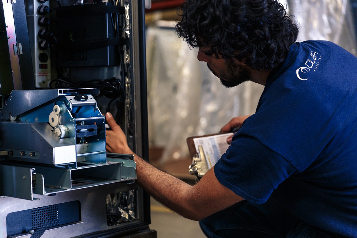 Employee Fixing a Kiosk at Olea